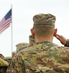 American soldier saluting American flag